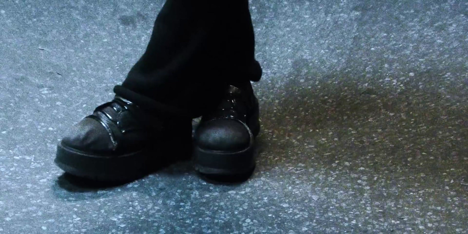 a close up of a person wearing black shoes