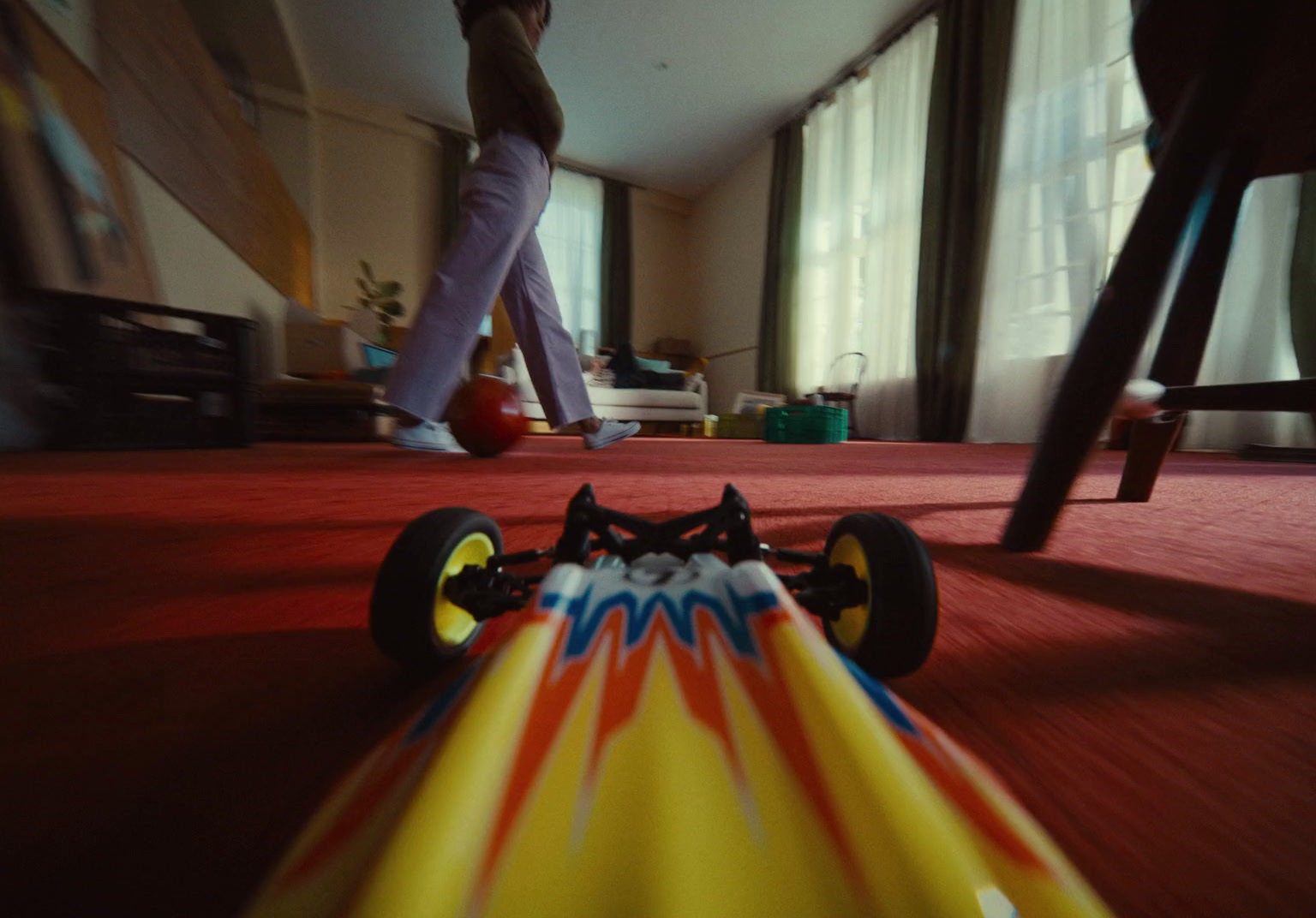 a toy car is on the floor of a living room