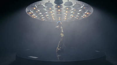 a person standing on top of a stage under a light