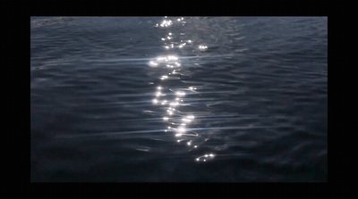 a long line of light reflecting off the water