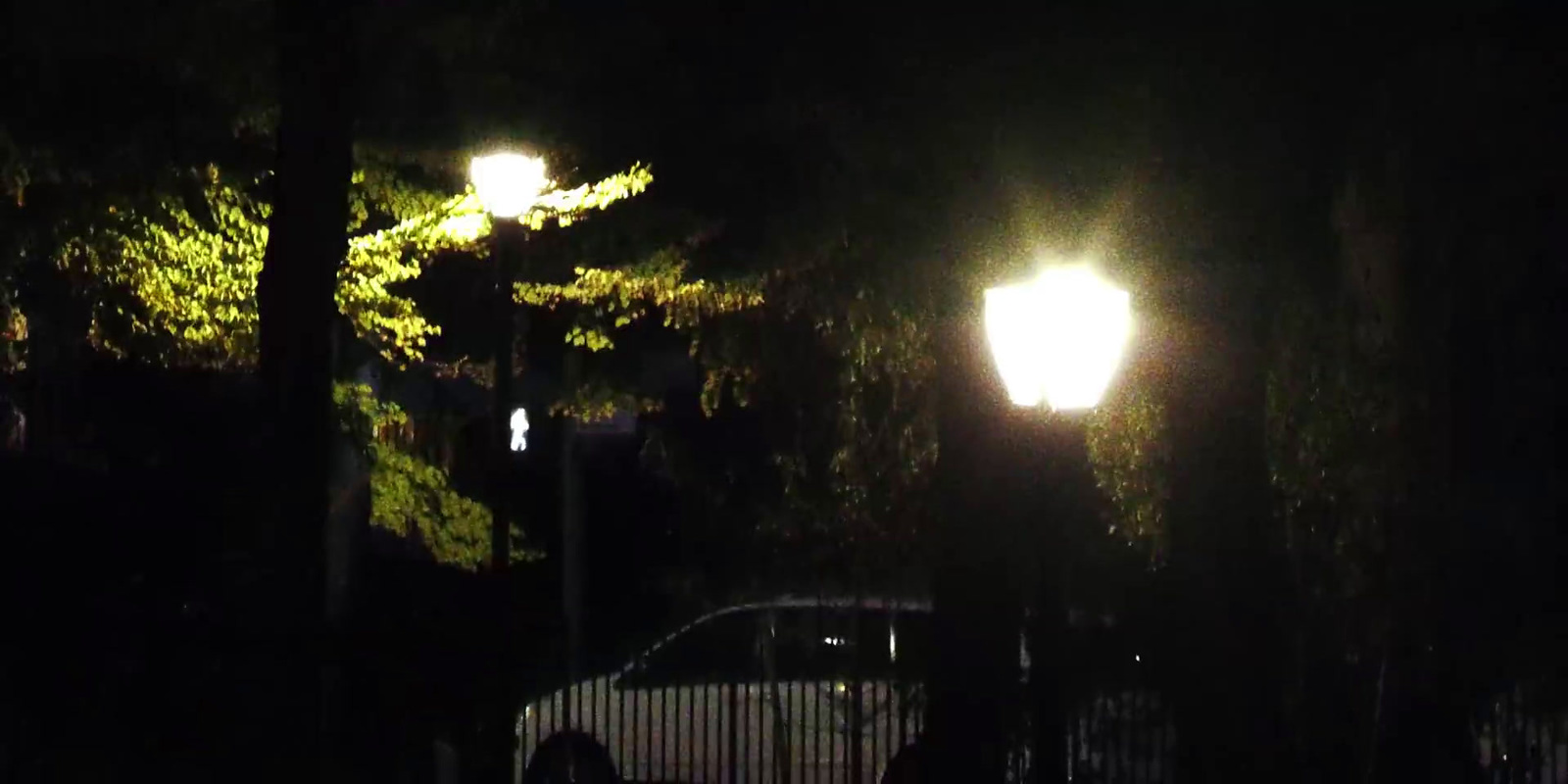 a car parked in the dark under a street light