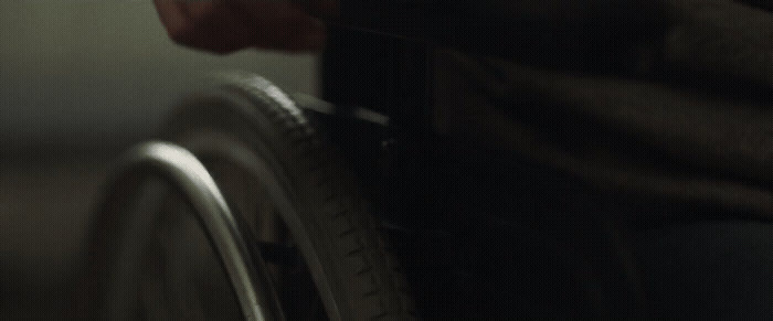 a close up of a person's hand on a wheel chair