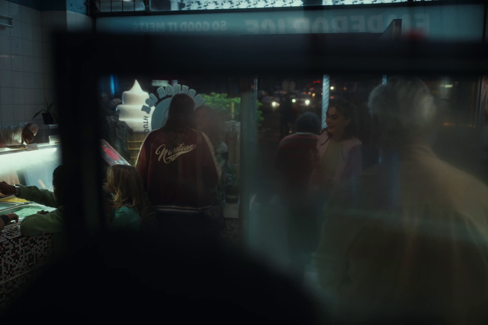 a group of people standing around a kitchen