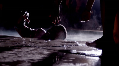 a group of people standing around a pool of water