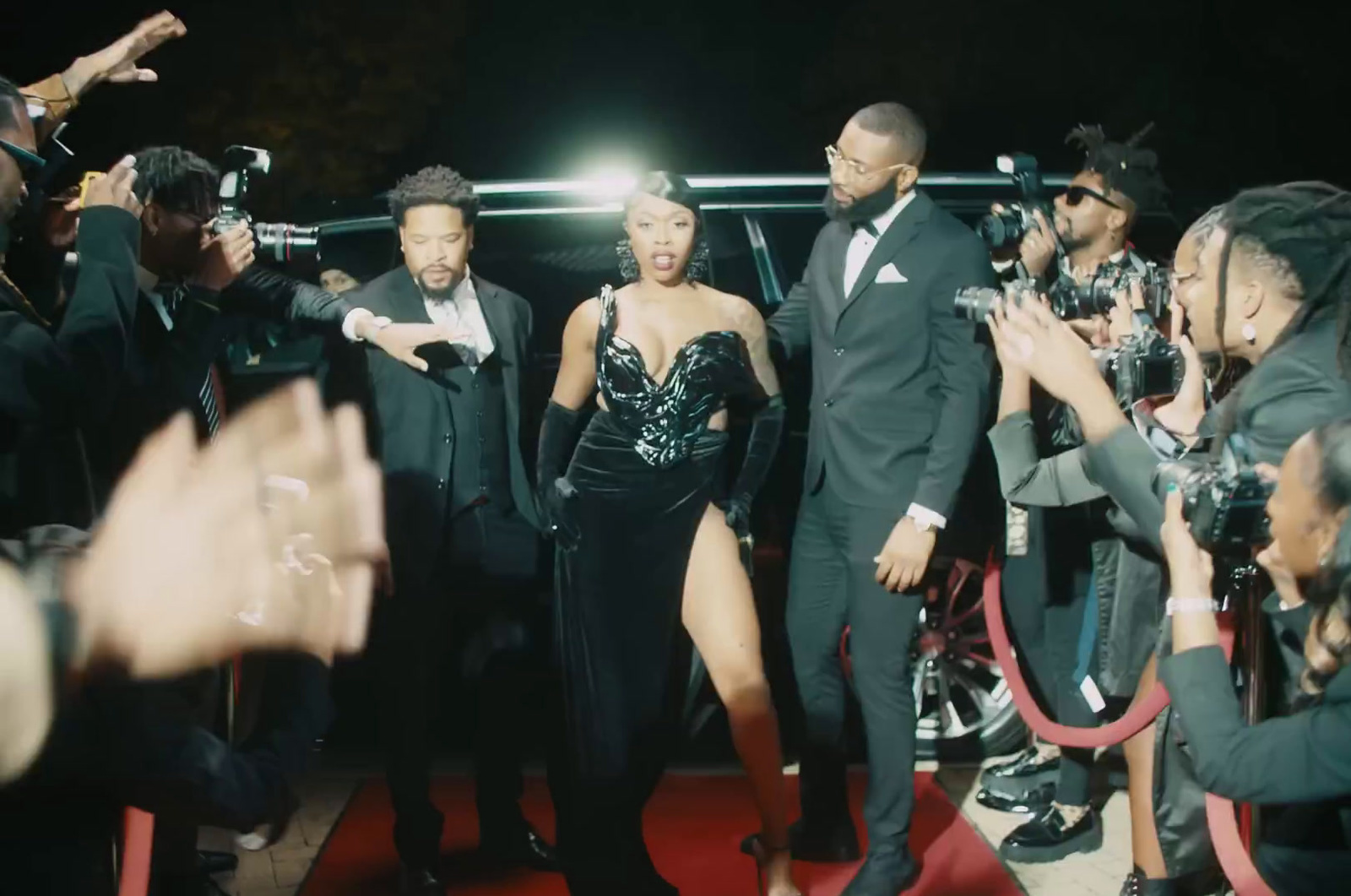 a group of people that are standing on a red carpet