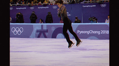 a man is doing a trick on an ice rink