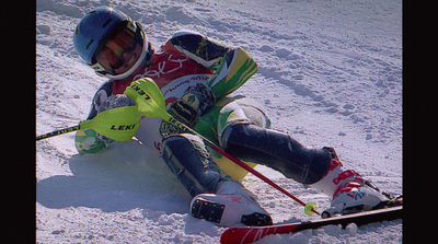 a man riding skis down a snow covered slope