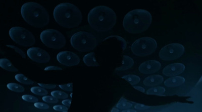 a person standing in front of a wall of bubbles