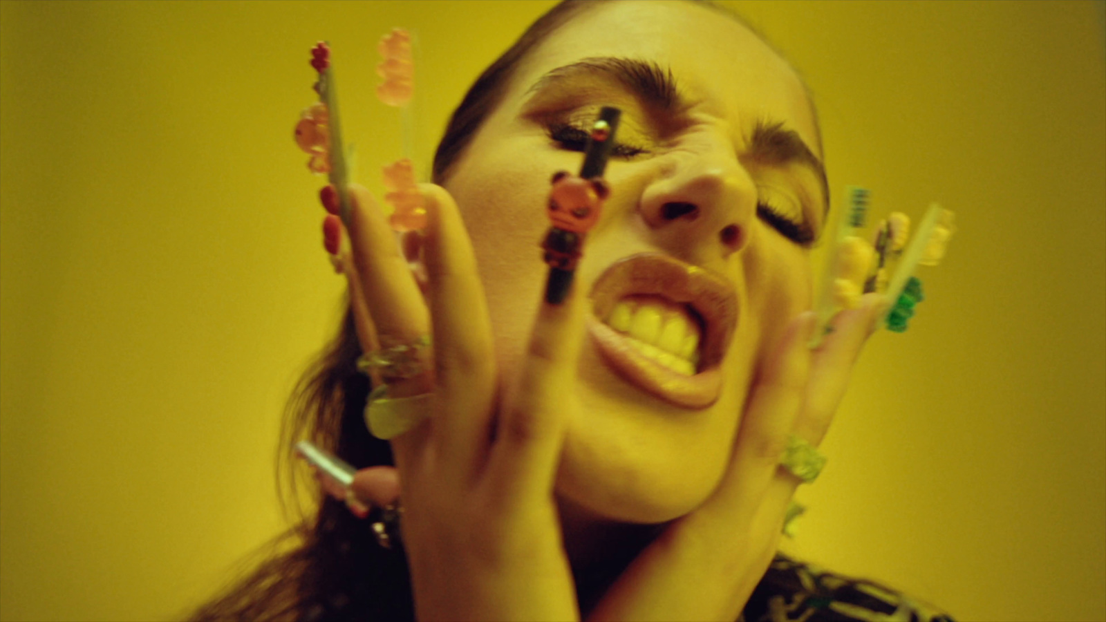 a woman with her hands on her face holding up toothbrushes