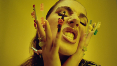 a woman with her hands on her face holding up toothbrushes