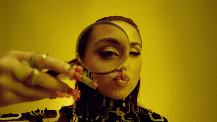 a woman looking through a magnifying glass