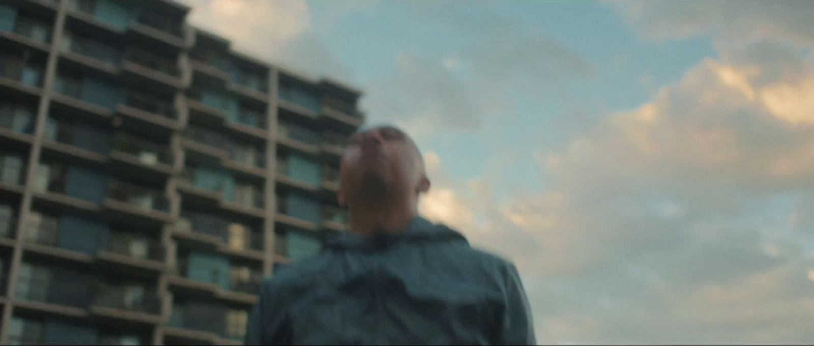 a man standing in front of a tall building