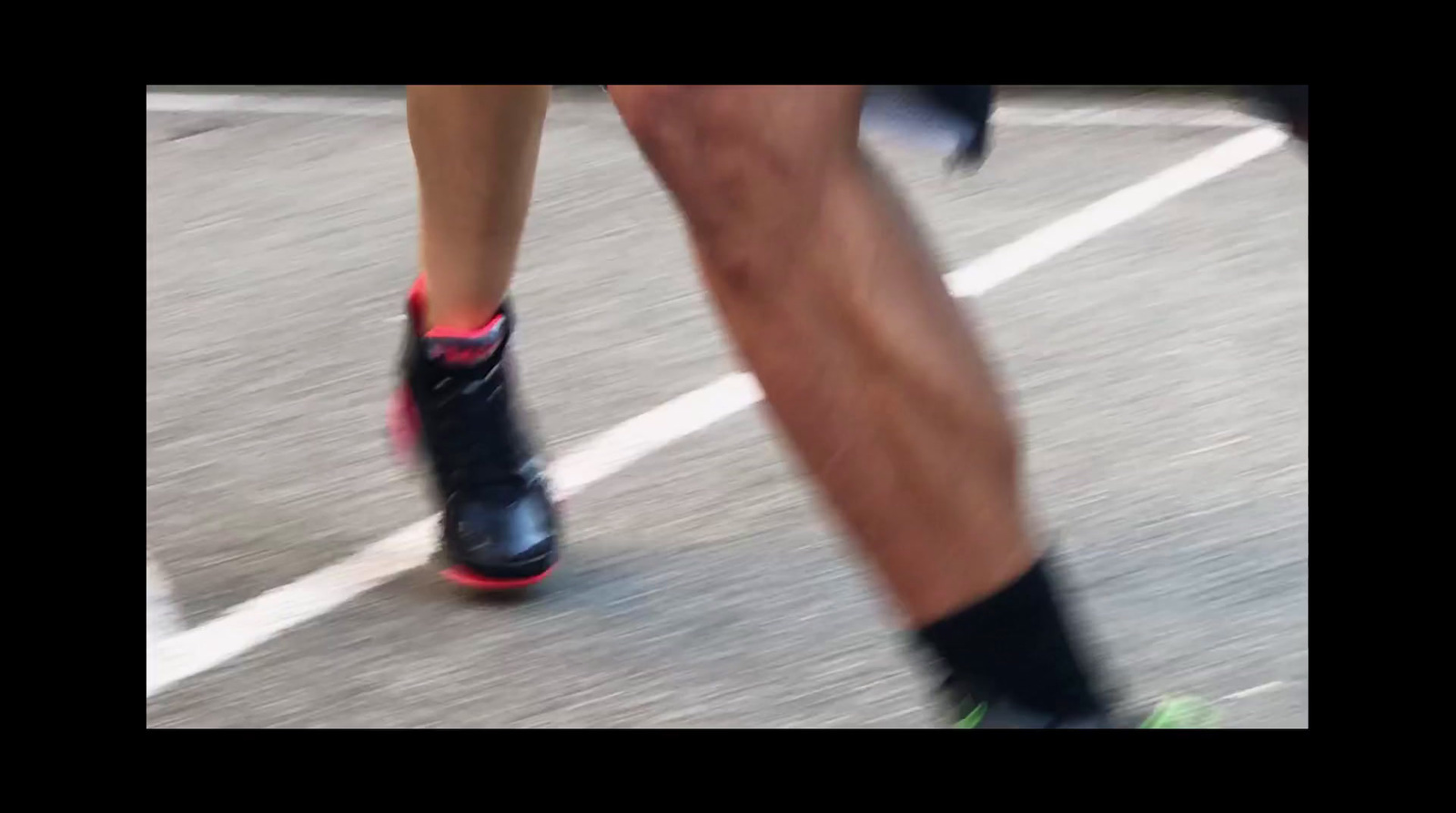 a close up of a person running on a street