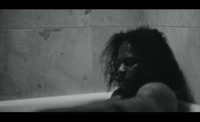 a black and white photo of a woman in a bathtub