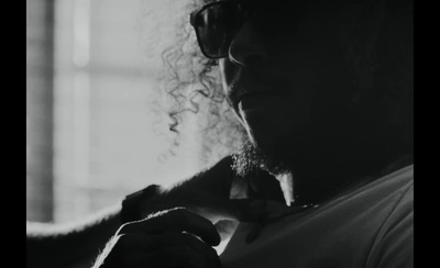 a man with long curly hair and sunglasses