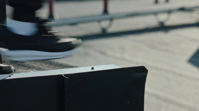 a skateboarder's feet and shoes on a ramp