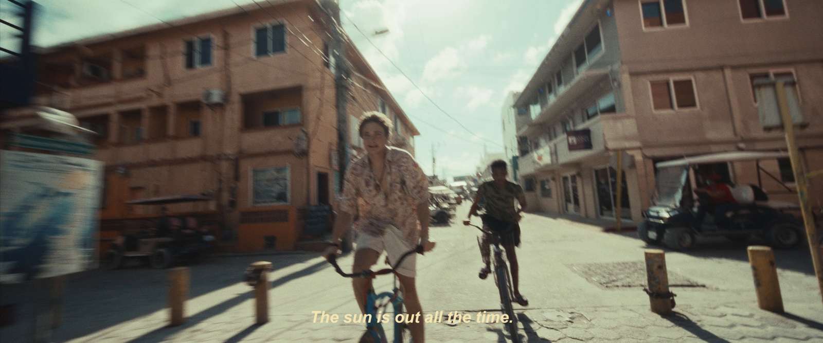 a couple of people riding bikes down a street