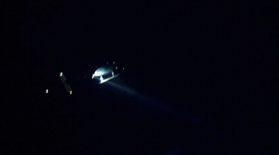 a person on a snowboard in the dark