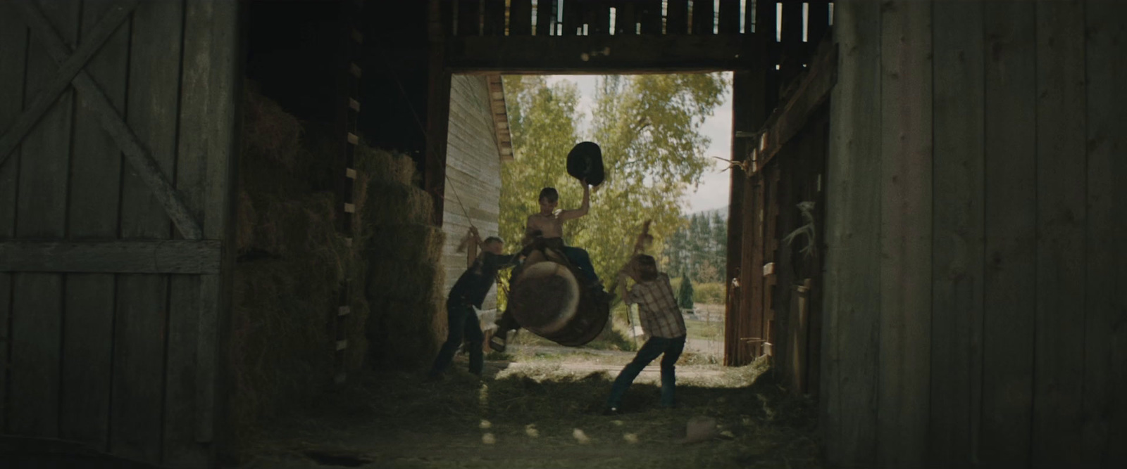 a group of people standing inside of a barn