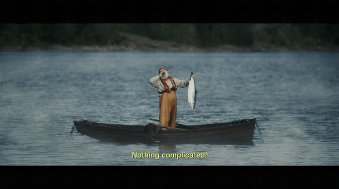 a man standing in a boat holding a fish