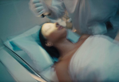 a woman laying in a hospital bed being examined