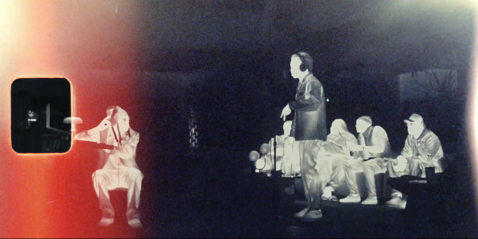 a black and white photo of people sitting at a table