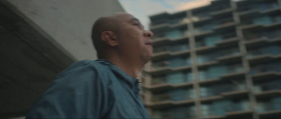 a man standing in front of a tall building