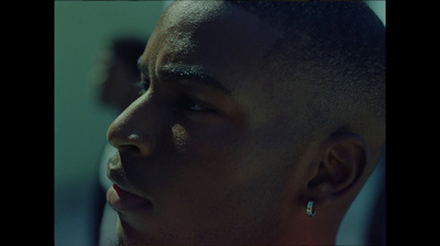 a close up of a person wearing a pair of earrings