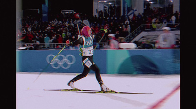 a person on skis in front of a crowd of people