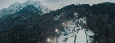 a snow covered mountain with a ski lift going down it