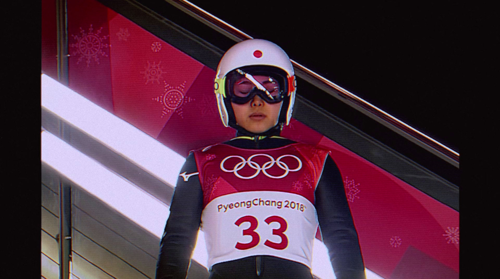 a woman wearing a ski suit and goggles