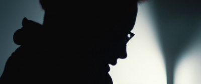 a silhouette of a person holding a cell phone