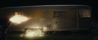 a person standing in front of a trailer at night