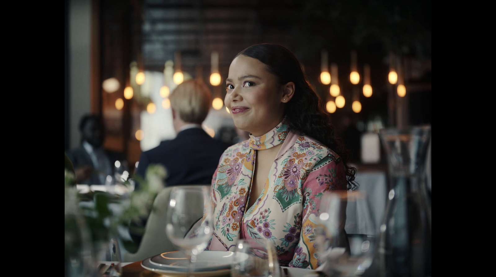 a woman sitting at a table in a restaurant