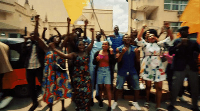 a group of people holding up yellow flags