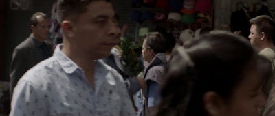 a man in a white shirt standing in front of a crowd of people