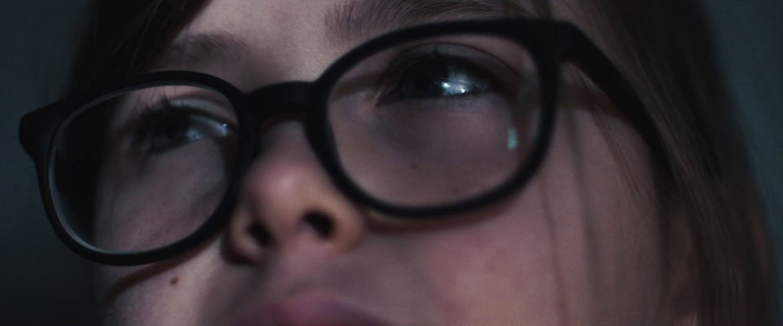 a close up of a person wearing glasses