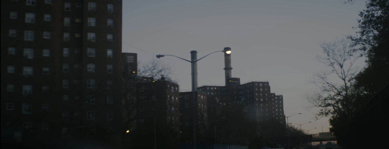 a view of a city street with tall buildings in the background