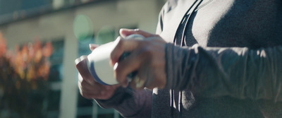 a close up of a person holding a cup