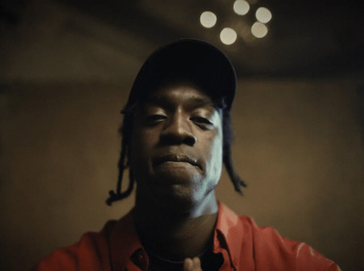 a man in a red shirt and a black hat