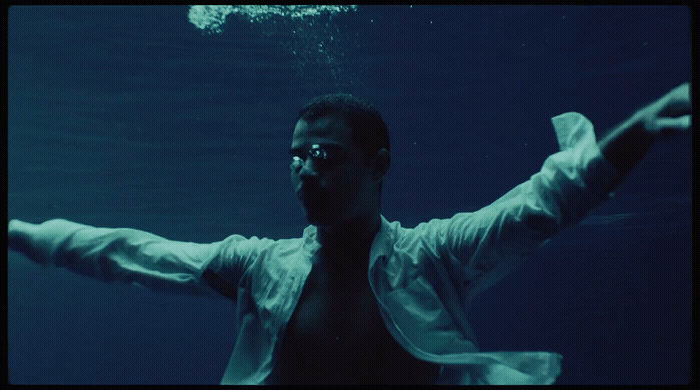 a man standing under water with his arms outstretched