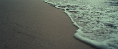 a beach with waves coming in to shore