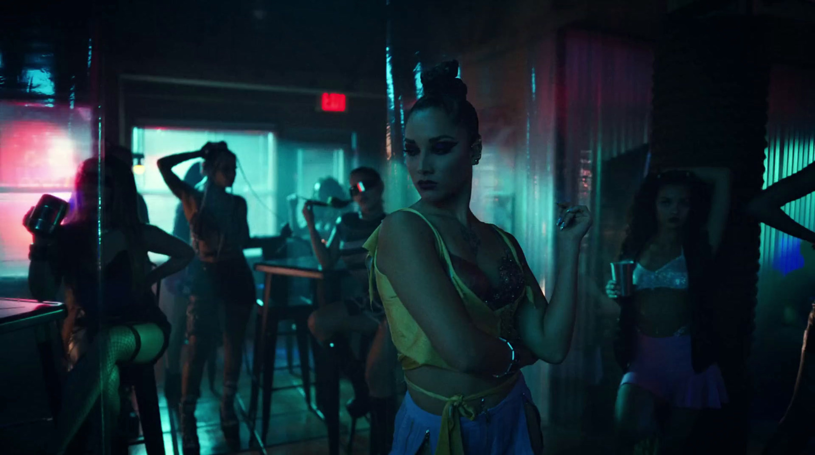 a group of women standing around a bar