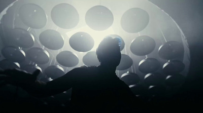 a man standing in front of a wall of balloons