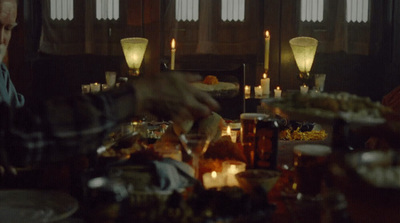 a group of people sitting around a table with food