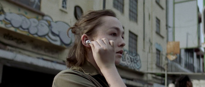 a woman talking on a cell phone in front of a building