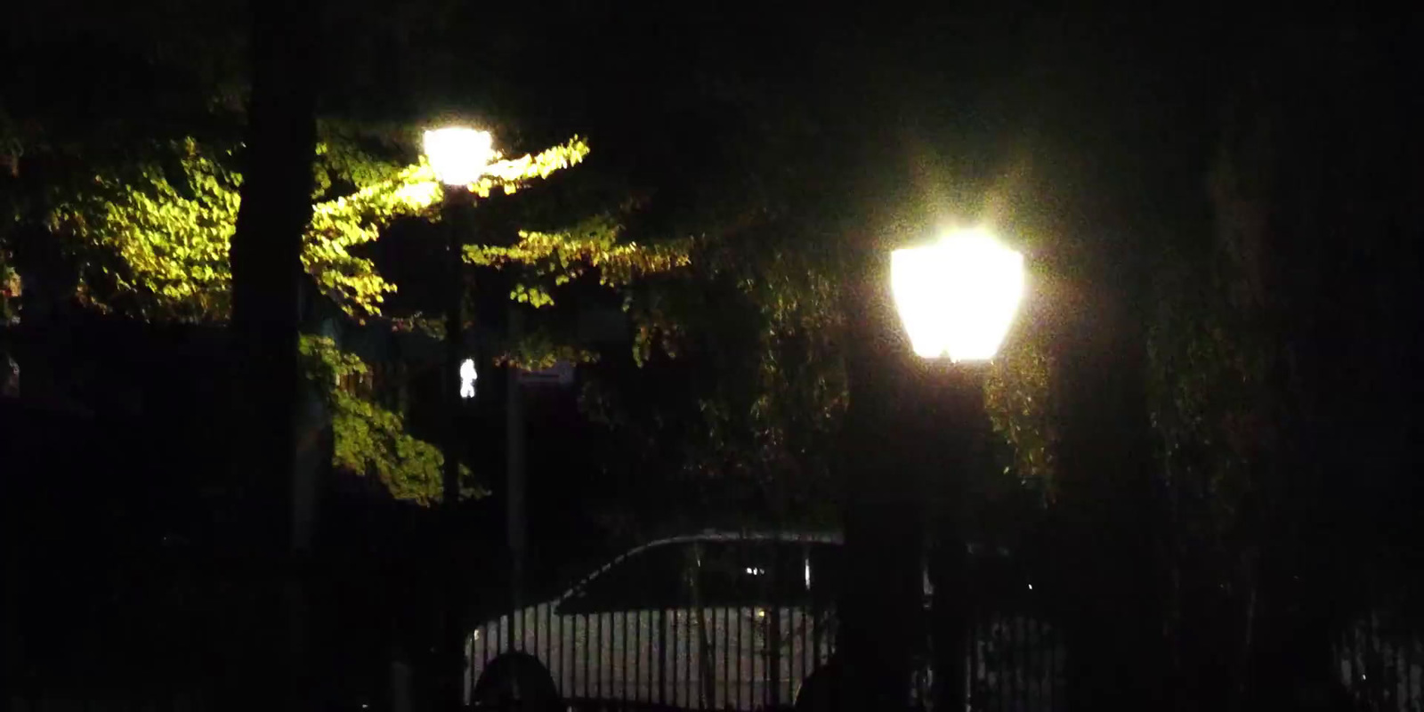 a car parked in the dark under a street light