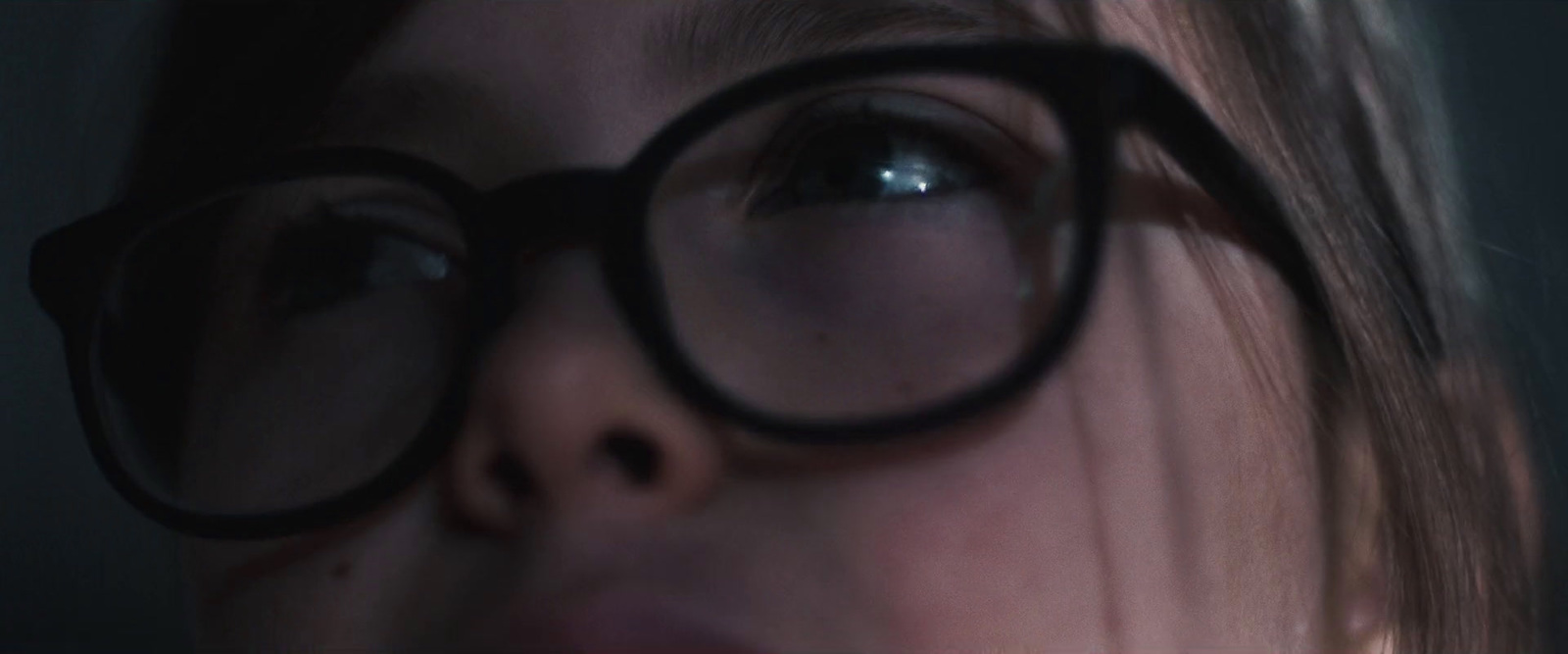 a close up of a person wearing a pair of glasses