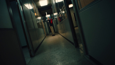 a person walking down a hallway in a building