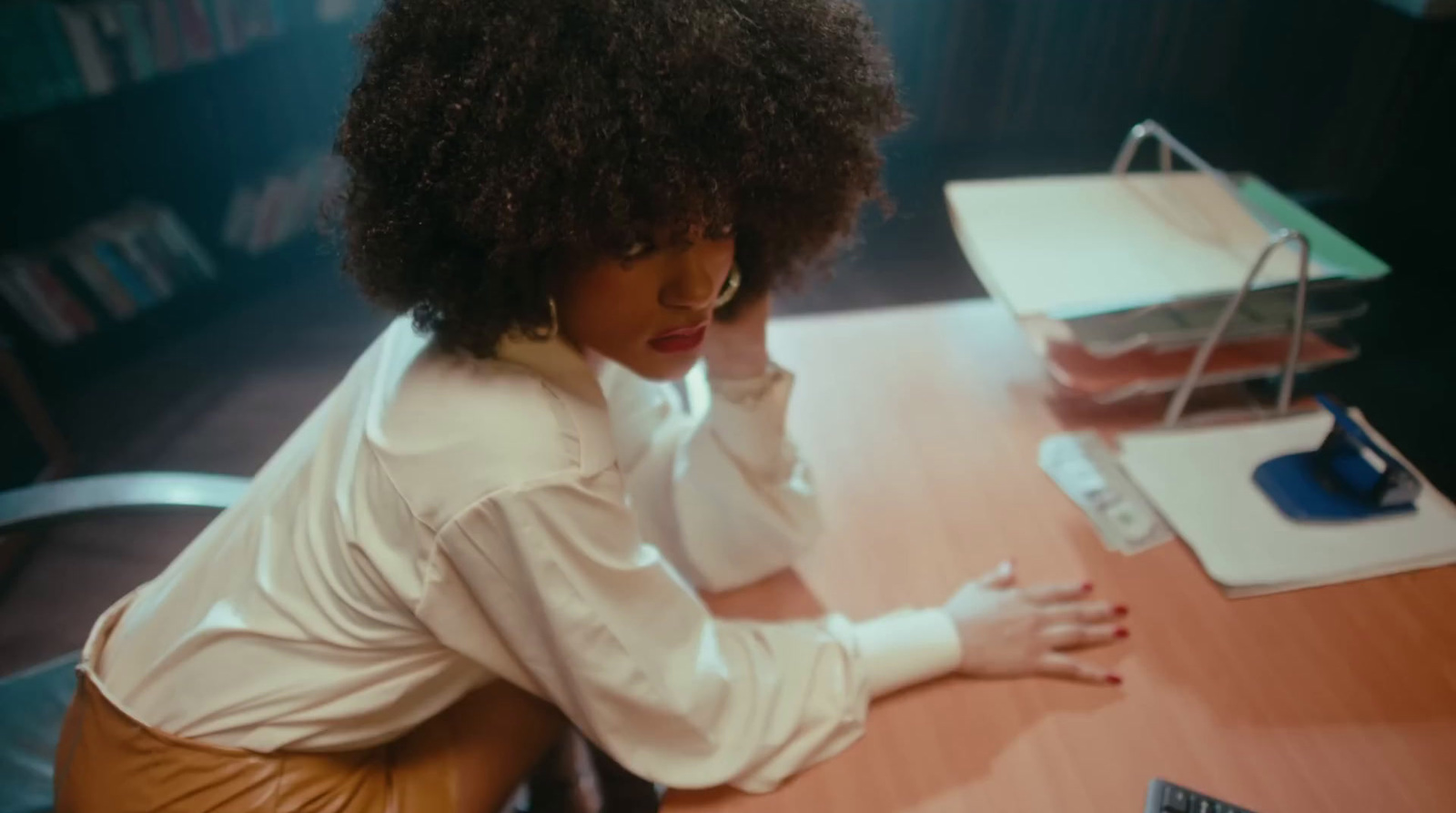 a woman sitting at a desk with a laptop computer